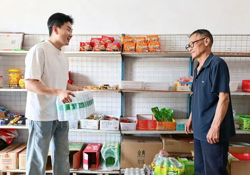 图为客户经理正在帮助零售商户整理货物.jpg